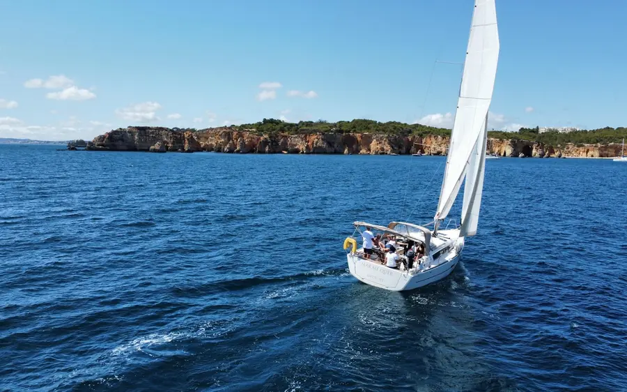 A sailing yacht under way off the Algarve coast
